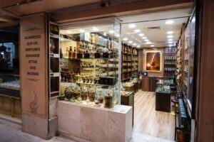shelves of agarwood and oud products. This grounds the where to buy section in a real